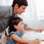 Parent guiding child during online schooling session with Albedo Educator